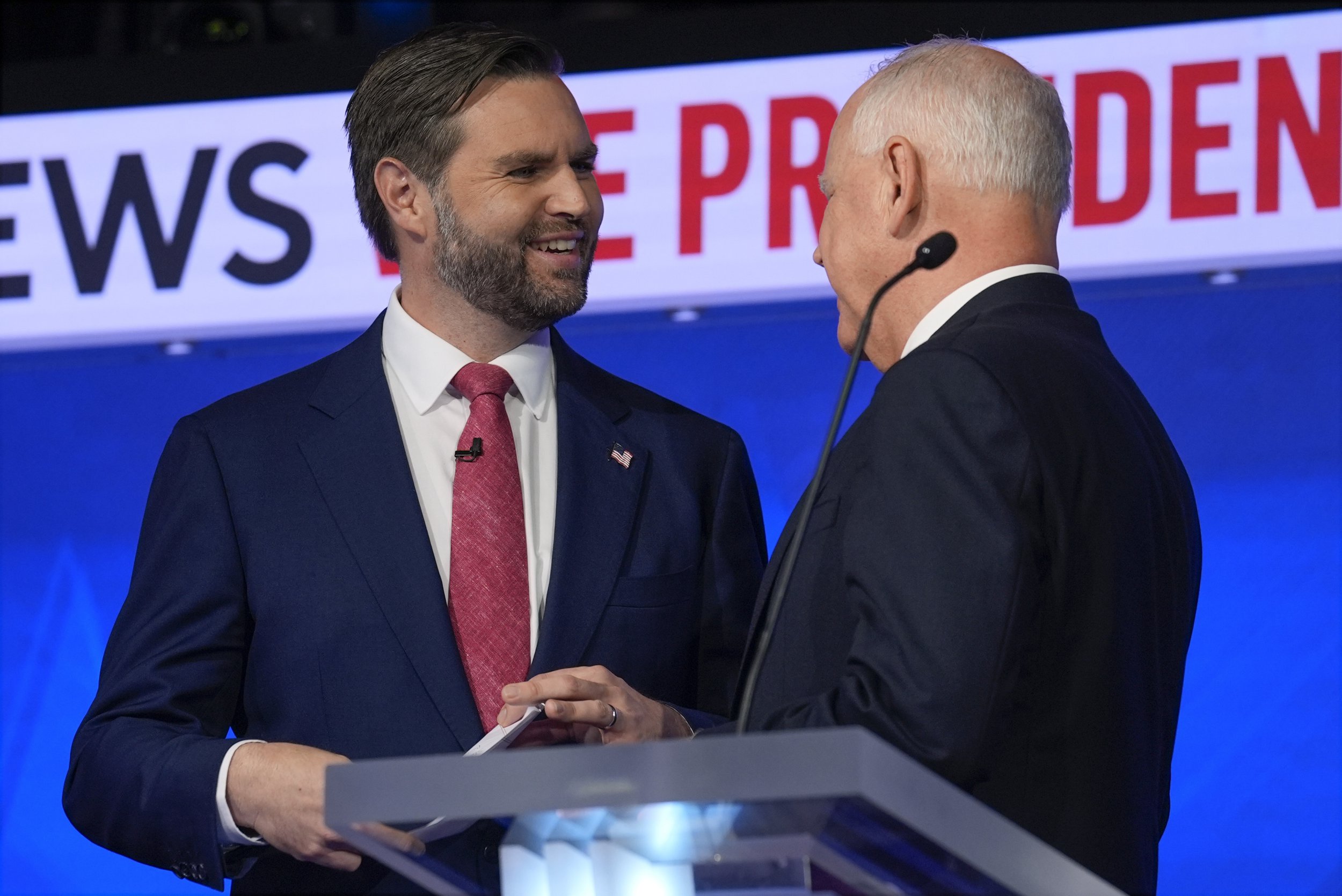 Republican vice presidential nominee Senator JD Vance (left) talks with Democratic vice presidential candidate Minnesota Governor Tim Walz (right) after the vice presidential debate hosted by CBS News Tuesday